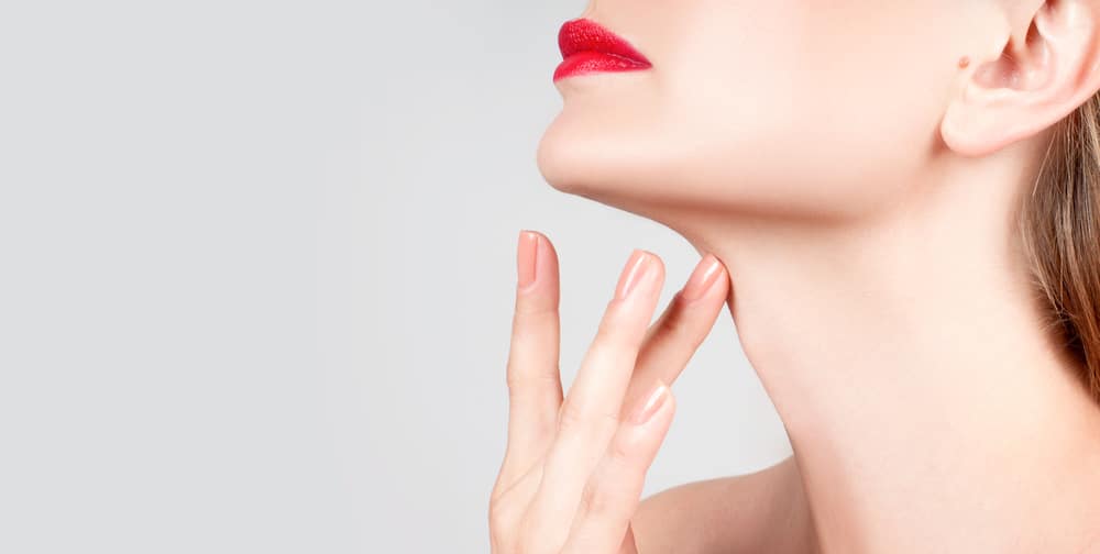 White woman displays her smooth neck after rejuvenating her lower face with cosmetic procedures.