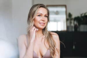 Woman in bra feels well a few weeks after her breast augmentation